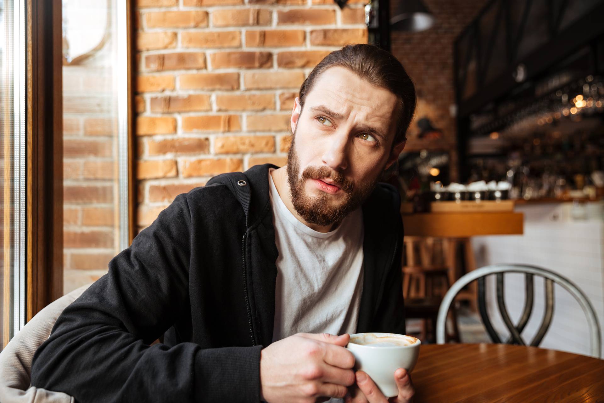 Serious Bearded man in cafe