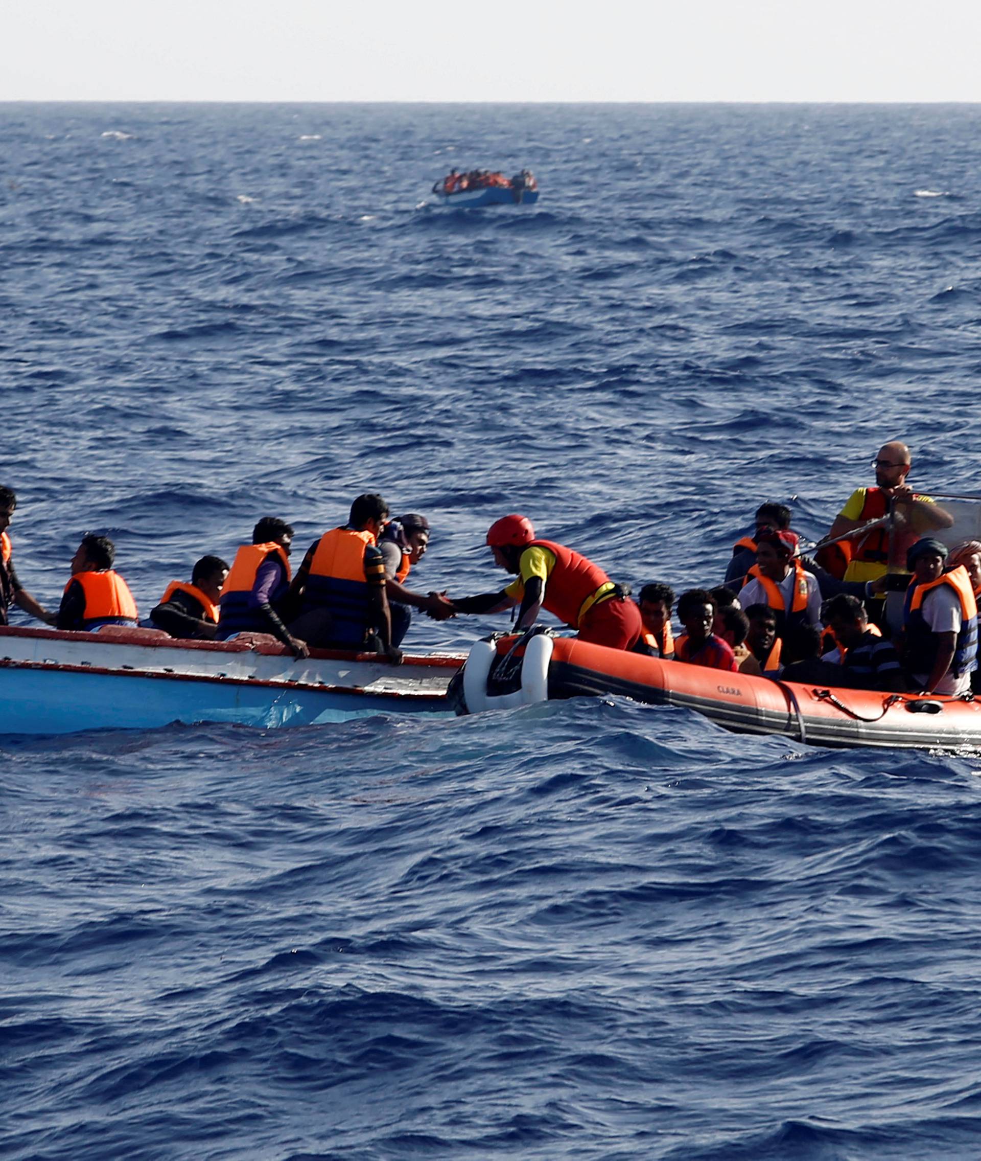An inflatable boat from the Spanish vessel Astral operated by the NGO Proactiva collects migrants off the Libyan coast in the Mediterranean Sea