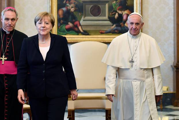 German Chancellor Merkel poses with Pope Francis during a meeting at the Vatican