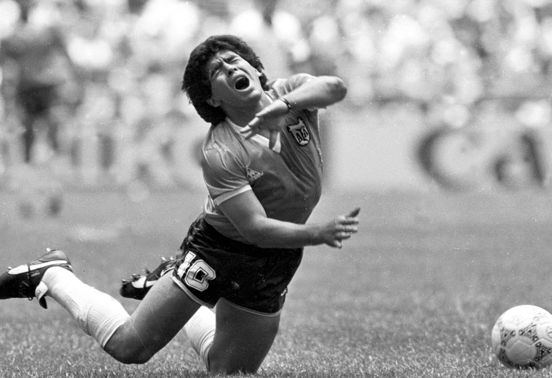FILE PHOTO: ARGENTINE DIEGO MARADONA FALLS TO THE PITCH IN WORLD CUP MATCH.
