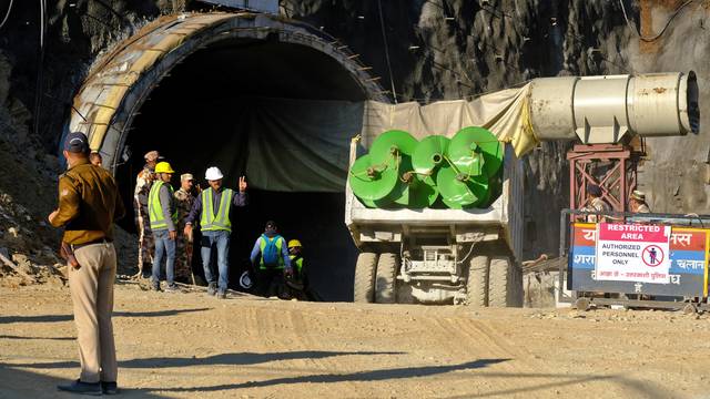 A supply truck loaded with augers prepares to enter a tunnel where 40 road workers are trapped after a portion of the tunnel collapsed in Uttarkashi