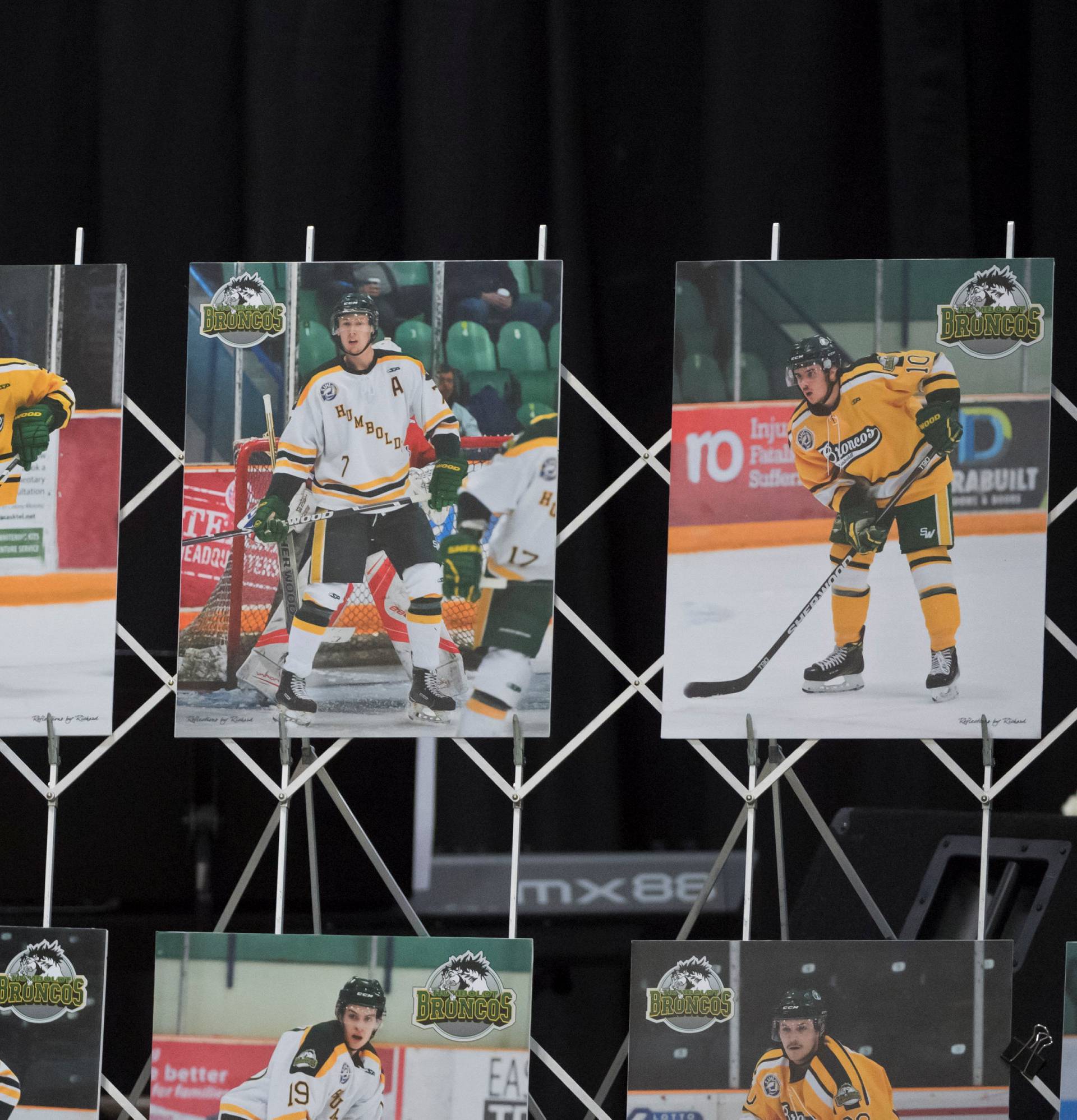 A man reacts as he looks at photographs before a vigil at the Elgar Petersen Arena, home of the Humboldt Broncos, to honour the victims of a fatal bus accident in Humboldt