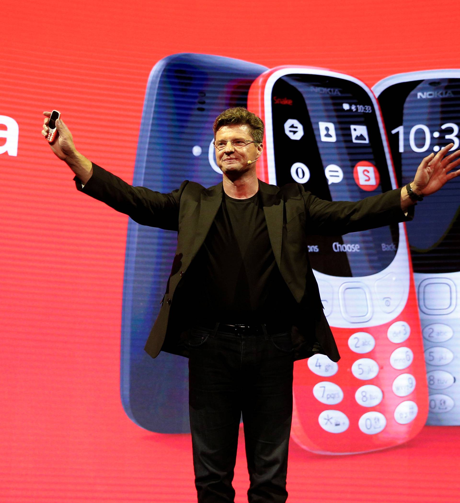 Nummela, CEO of Nokia-HMD, holds up Nokia 3310 device during presentation ceremony at Mobile World Congress in Barcelona
