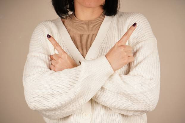 The gesture conveys creativity, focus, and a spark of inspiration. A dynamic moment filled with innovation and insight. A raised index finger signals the birth of an idea, drawing attention.