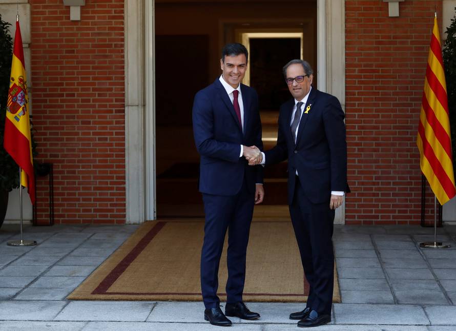 Spain's Prime Minister Pedro Sanchez greets pro-independence Catalan leader Quim Torra at the Moncloa Palace in Madrid