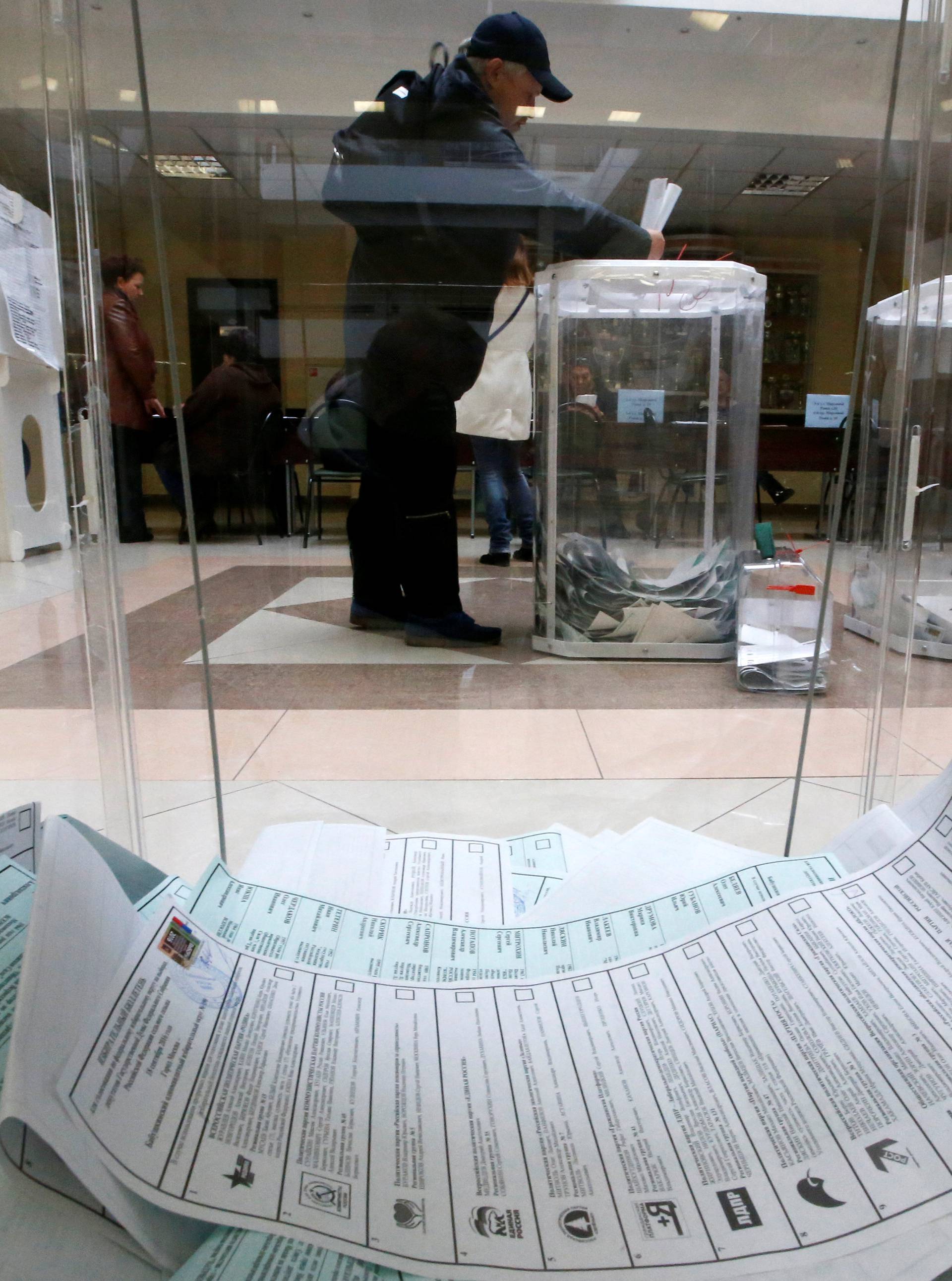 Man casts his ballot at polling station during parliamentary election in Moscow