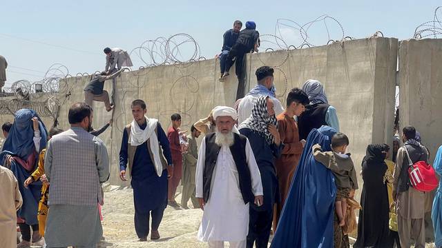 People try to get inside Hamid Karzai International Airport in Kabul