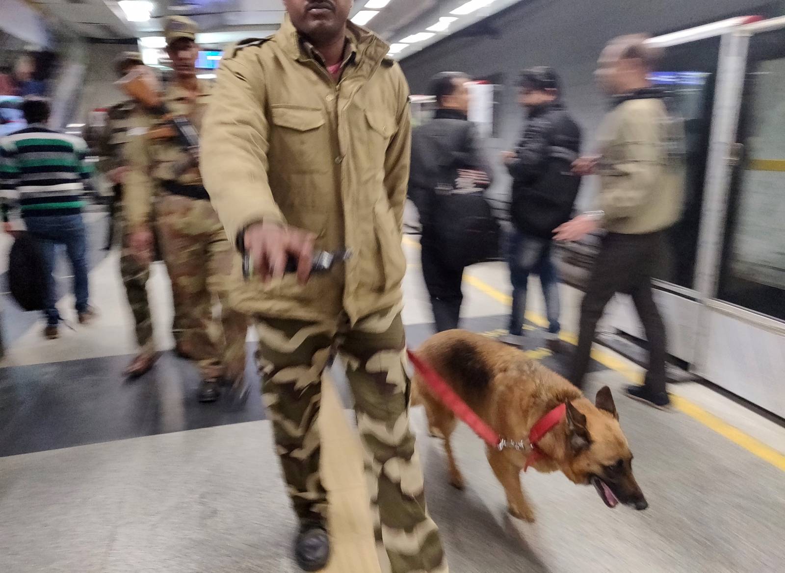 Members of Central Industrial Security Force with a sniffer dog patrol inside a metro station in New Delhi,