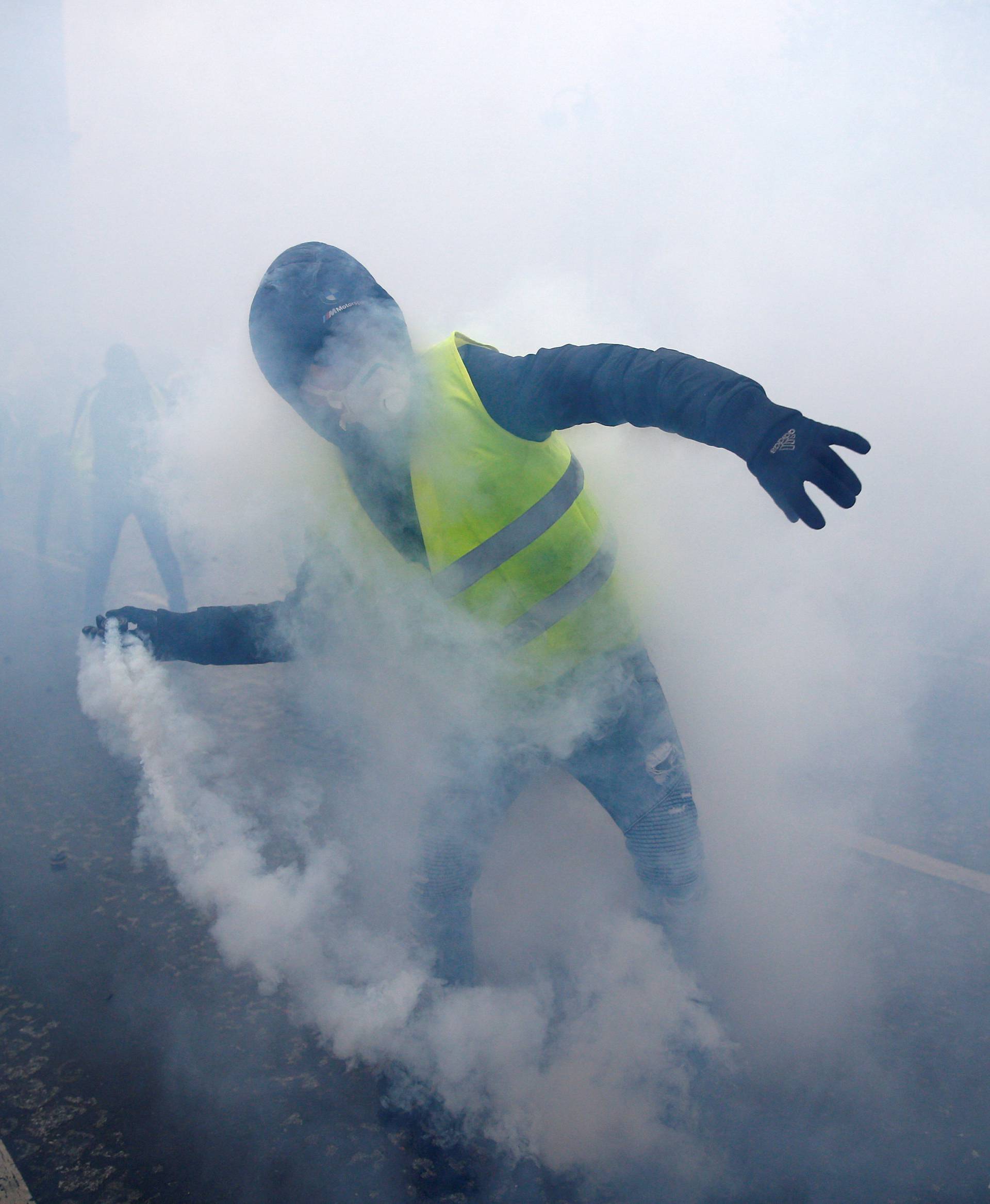 A protester wearing a yellow vest, a symbol of a French drivers' protest against higher diesel taxes, demonstrates near the Place de l'Etoile in Paris