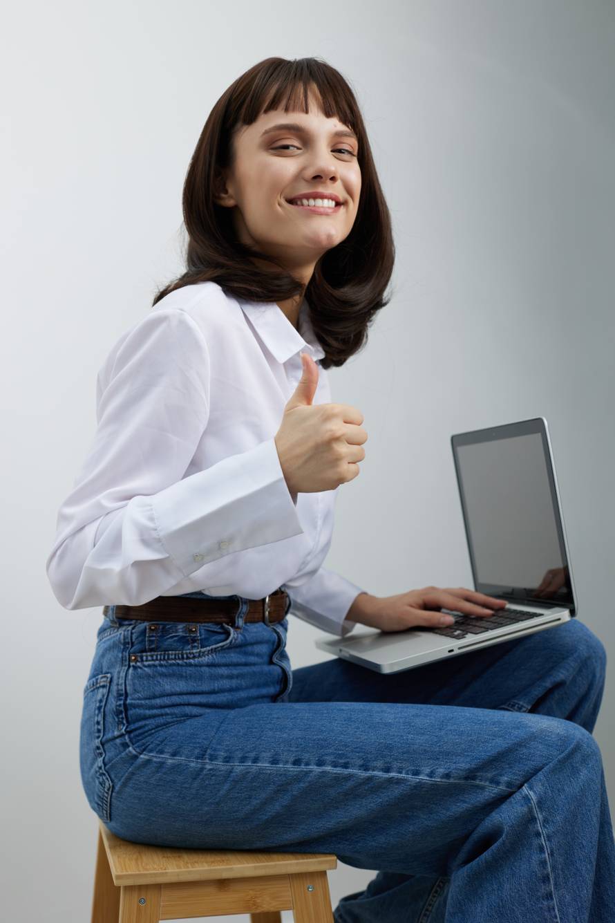 Bright,Young,Woman,Sits,On,A,Wooden,Stool,With,A