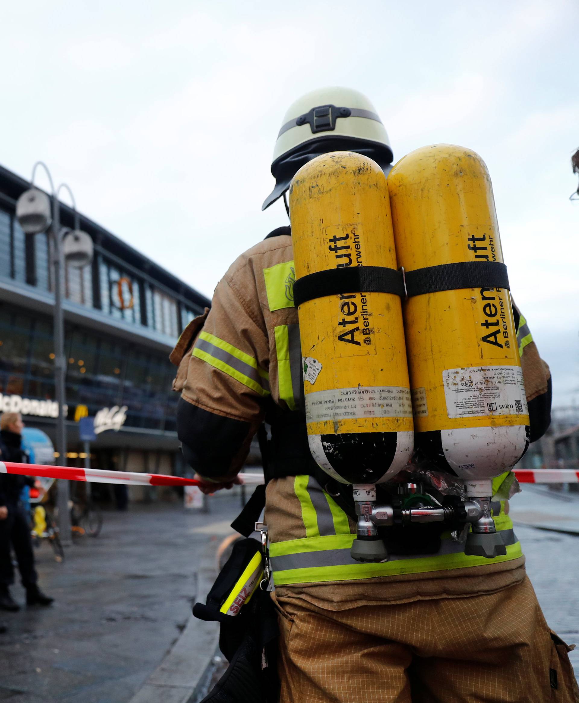 A firefighter stands outside the Berlin's Zoo train station after a large amount of smoke was detected and several people were rescued from the scene in Berlin