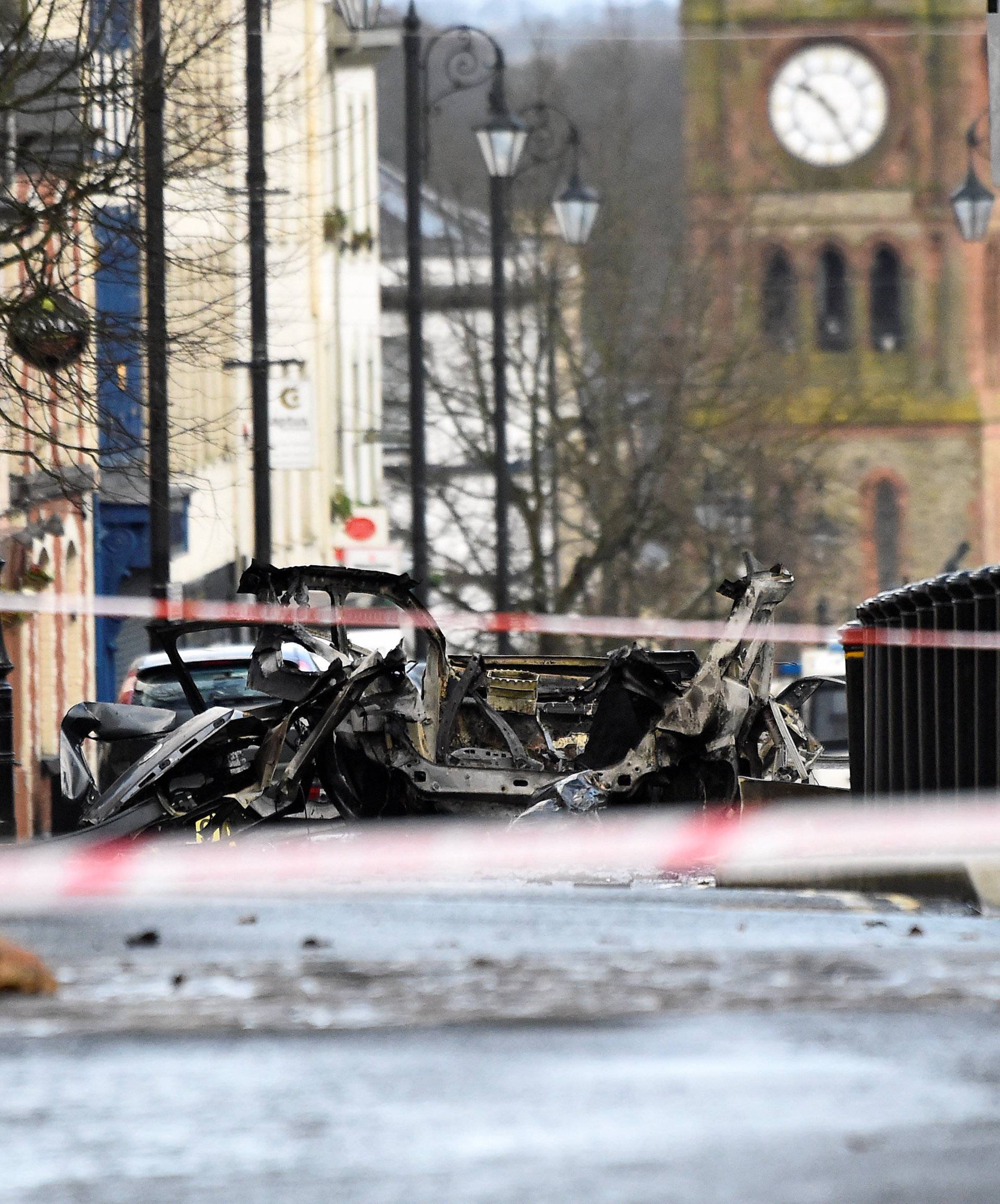 Police officers guard the scene of a suspected car bomb in Londonderry