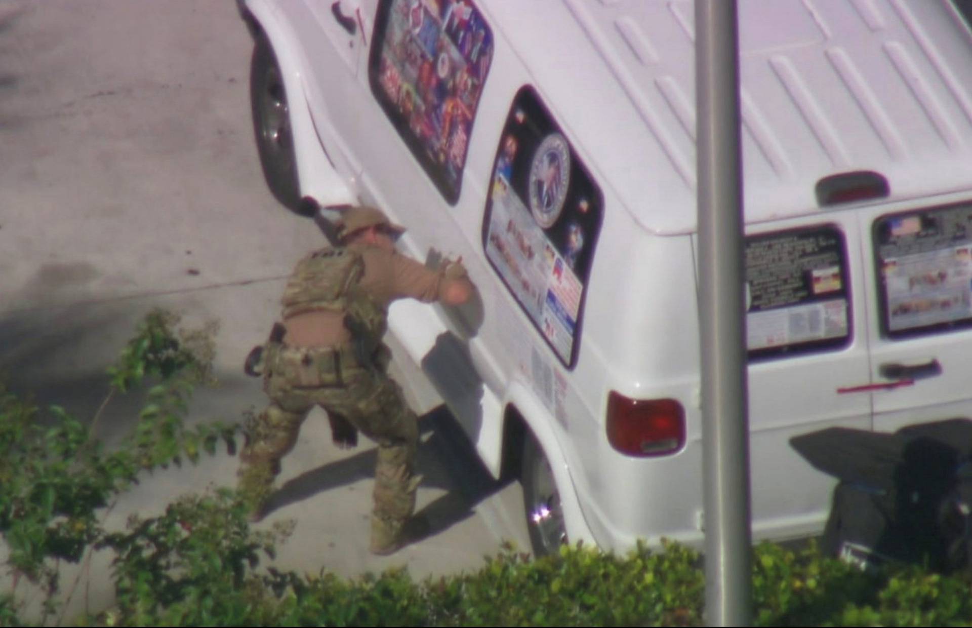 A law enforcement officer checks a van which was seized during an investigation into a series of parcel bombs, in Plantation