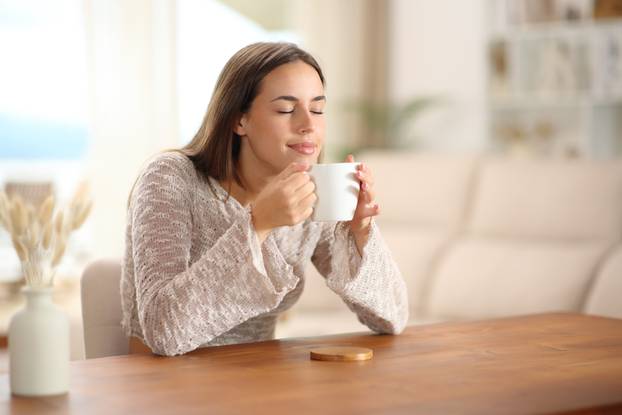 Coffee,Lover,Smelling,Aroma,From,Cup,On,A,Table,At