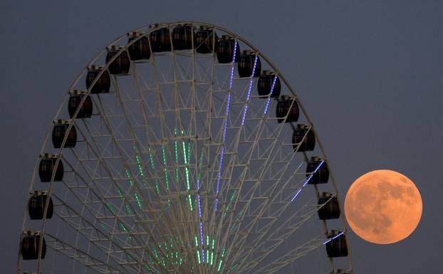 The "Blood Moon" rises in the sky during a total lunar eclipse,in Baghdad