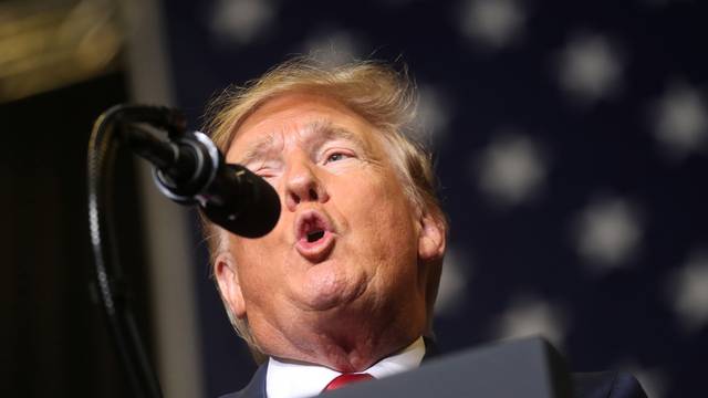 U.S. President Donald Trump reacts during a campaign rally in Tupelo