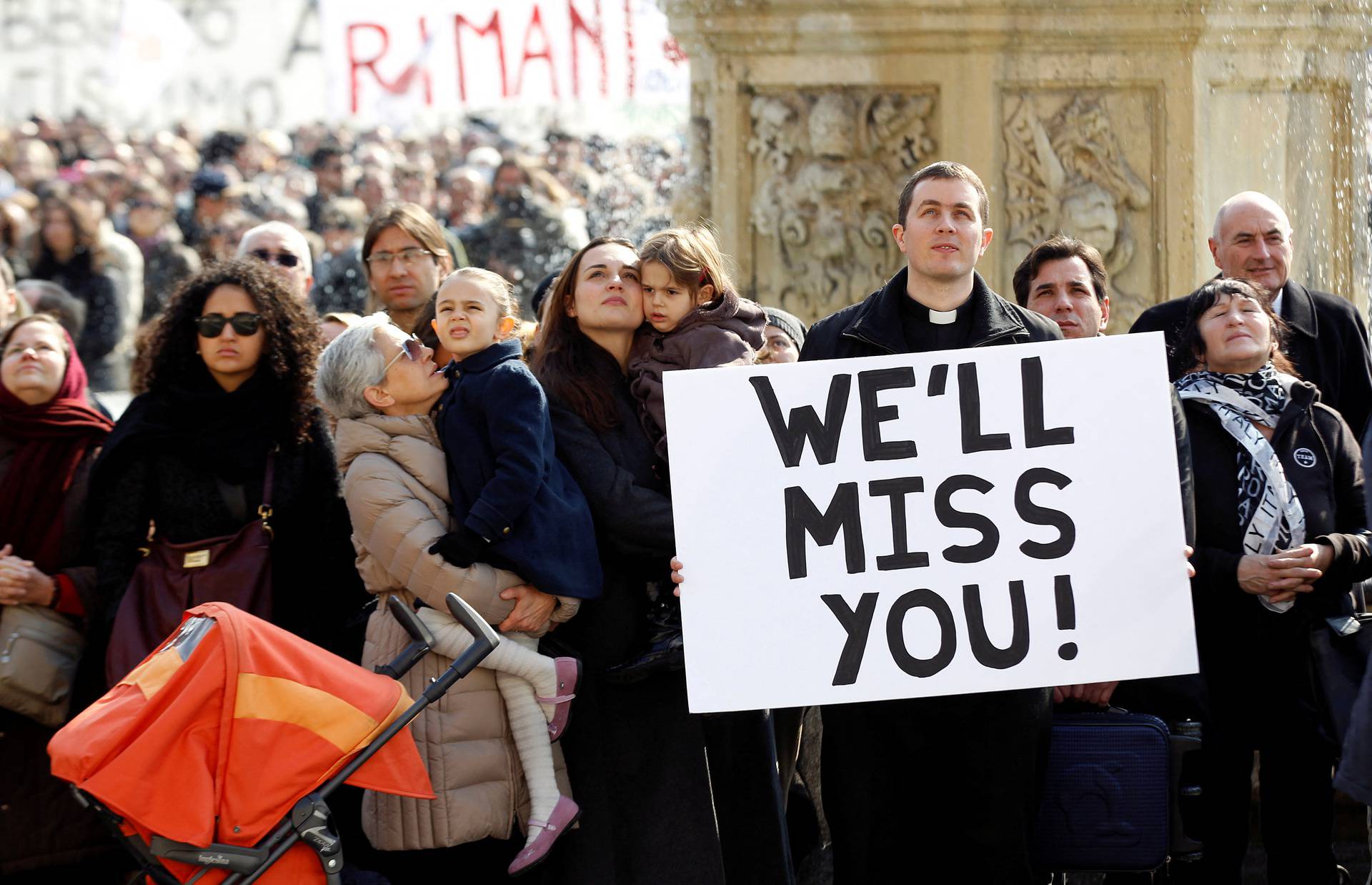 FILE PHOTO: Faithful hold a sign as Pope Benedict XVI leads the Sunday Angelus in Saint Peter's Square at the Vatican