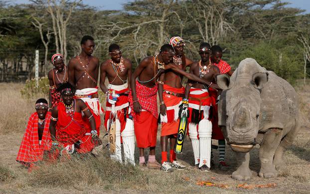 FILE PHOTO: Members of the Maasai Cricket Warriors pose for a photograph with the last surviving male northern white rhino in Laikipia