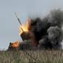 FILE PHOTO: Ukrainian servicemen fire a Multiple Launch Rocket System towards Russian troops near the frontline town of Pokrovsk