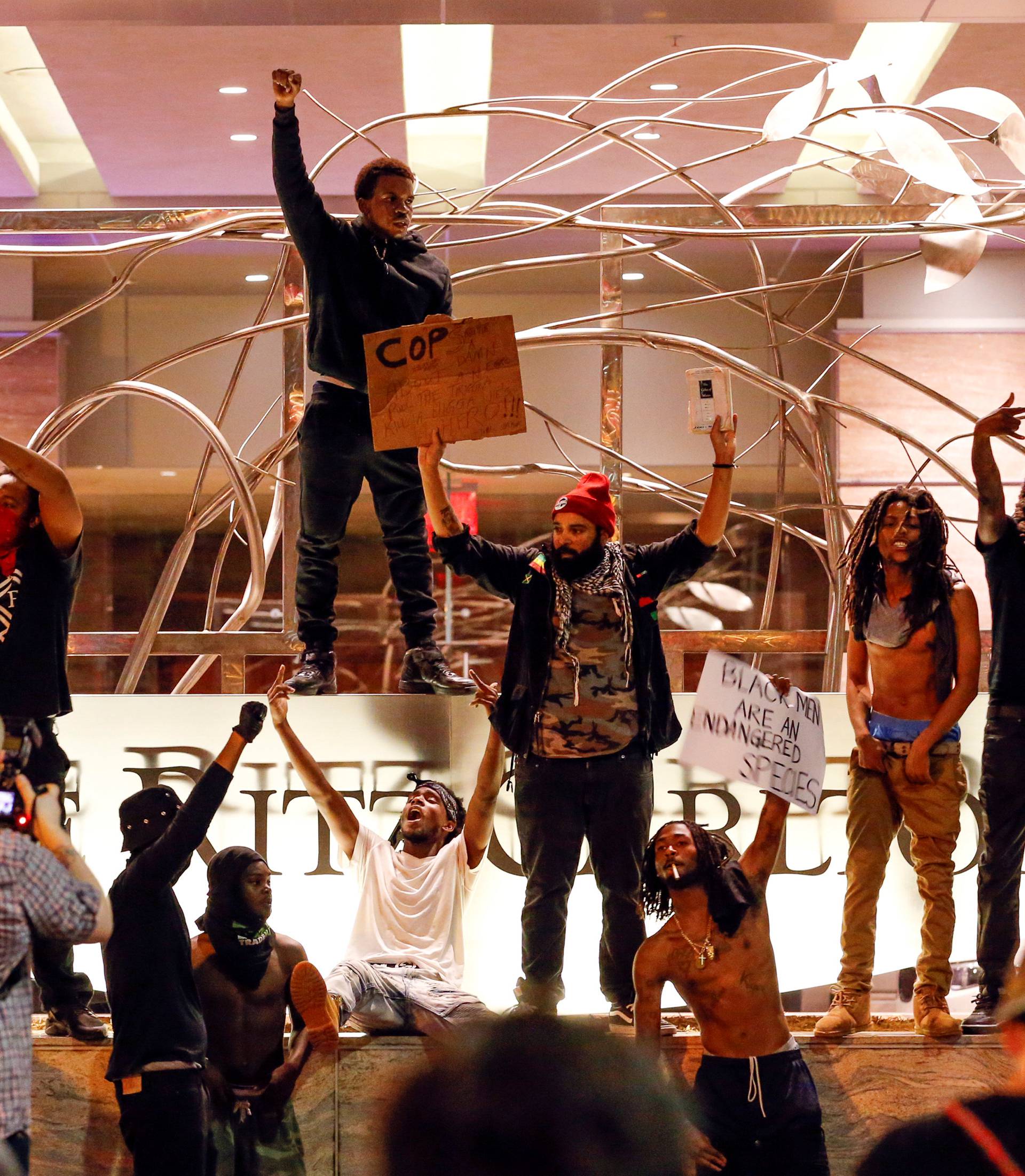 People gather in front of the Ritz-Carlton in uptown Charlotte, NC during a protest of the police shooting of Keith Scott, in Charlotte