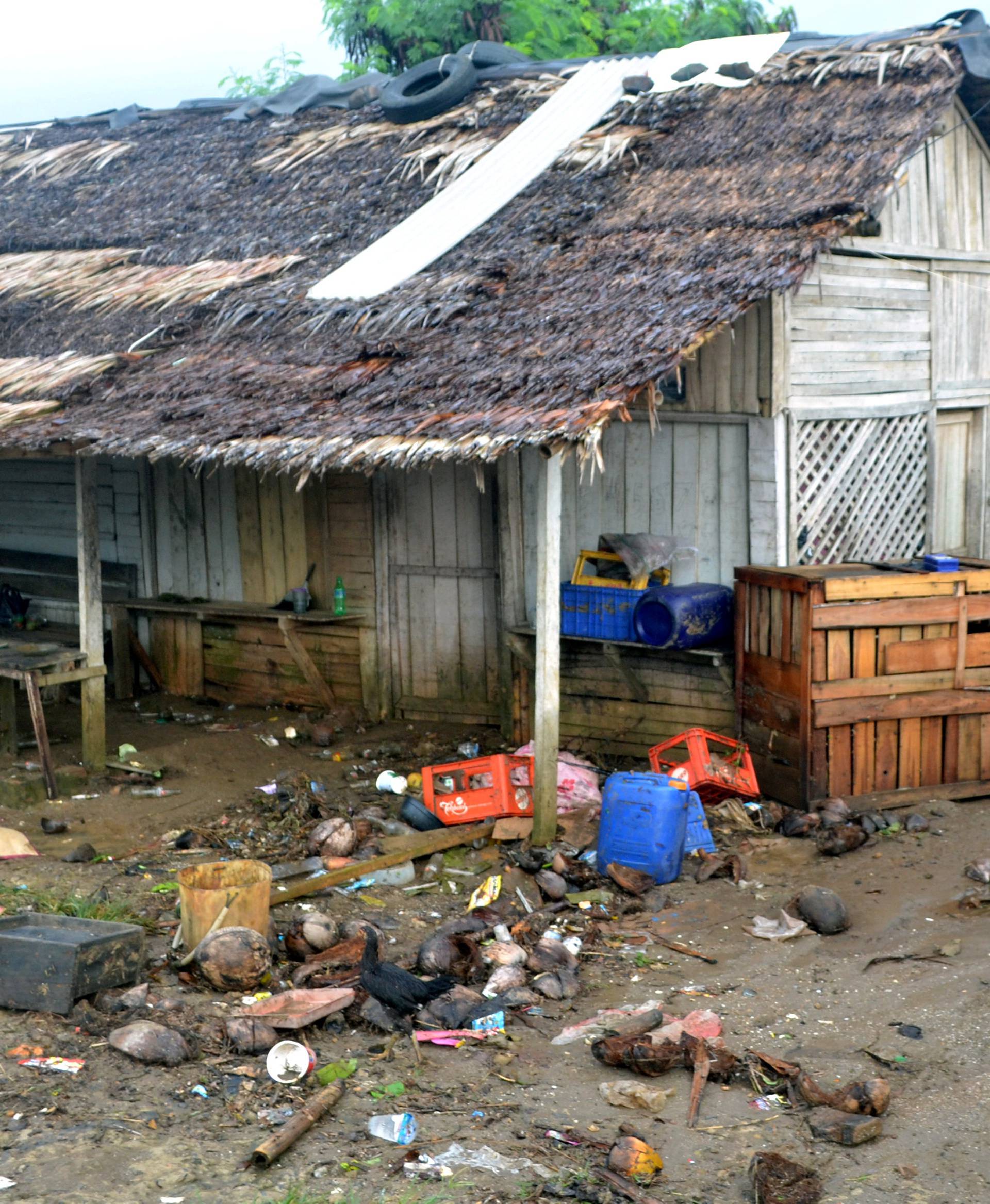 A local walks near her damaged house hit by tsunami at Tanjung Lesung district in Pandeglang, Banten province