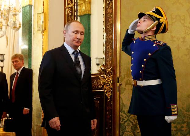 Russian President Putin enters hall during meeting with Uzbekistan President Karimov at Kremlin in Moscow