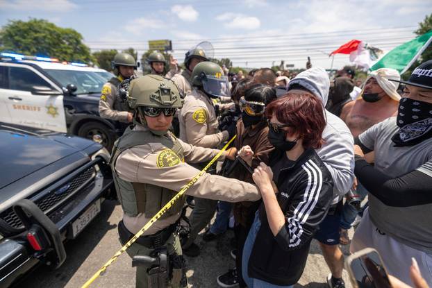 Standoff by protesters and law enforcement, following multiple detentions by ICE in Los Angeles County