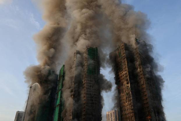 Flames engulf bamboo scaffolding across multiple buildings at Wang Fuk Court housing estate, in Tai Po