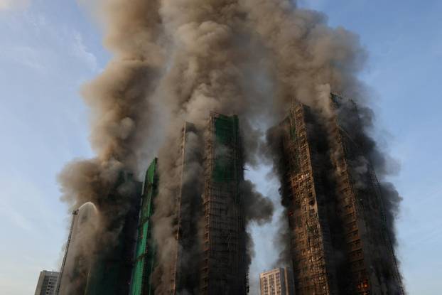 Flames engulf bamboo scaffolding across multiple buildings at Wang Fuk Court housing estate, in Tai Po