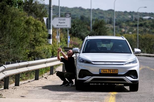 A man reacts as siren sounds following incoming rockets from Lebanon to Israel near Shlomi, northern Israel