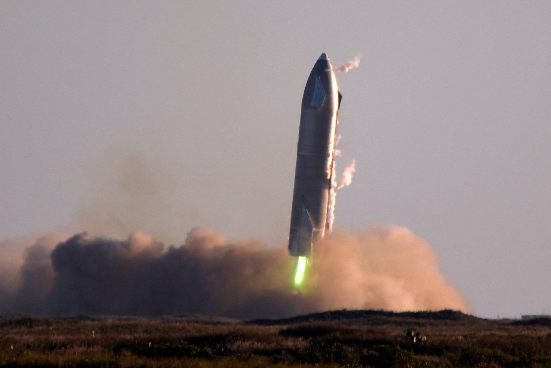 SpaceX's first super heavy-lift Starship SN8 rocket during a return-landing attempt after it launched from their facility on a test flight in Boca Chica, Texas