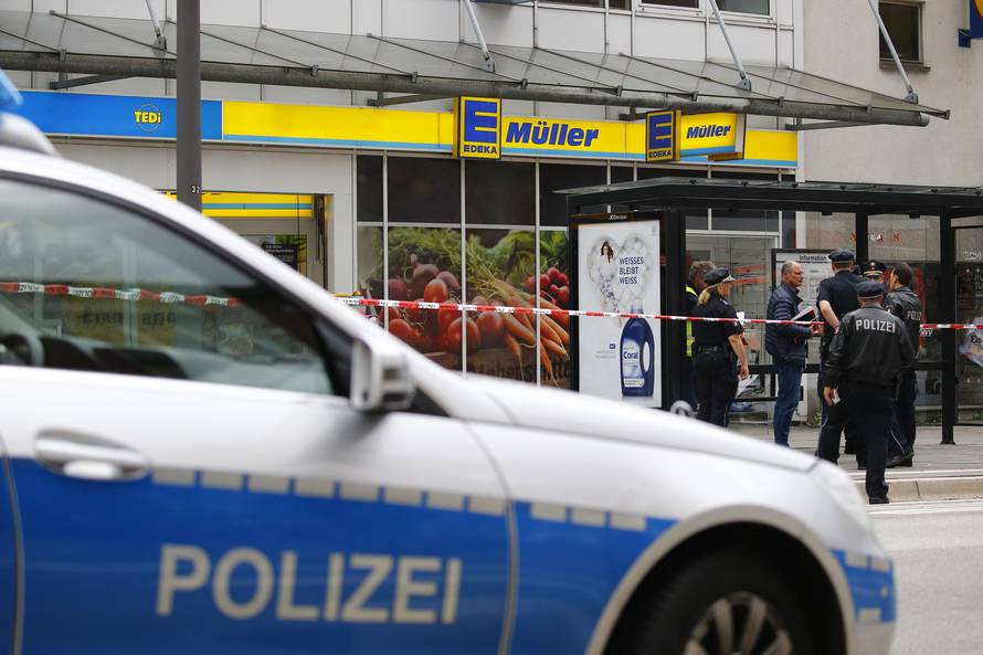 Security forces are seen after a knife attack in a supermarket in Hamburg