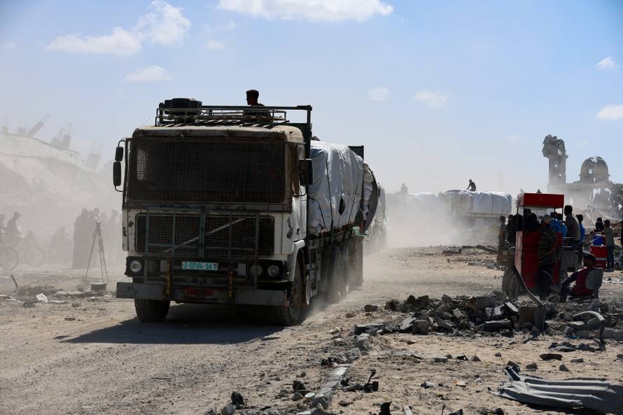 Trucks carry aid for Palestinians in Khan Younis