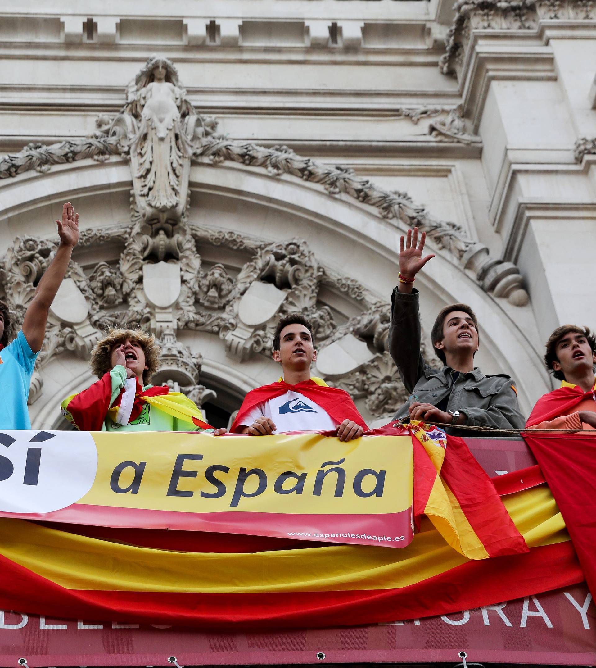 Demonstrators shout from a balcony of the city hall during a demonstration in favor of a unified Spain a day before the banned October 1 independence referendum, in Madrid
