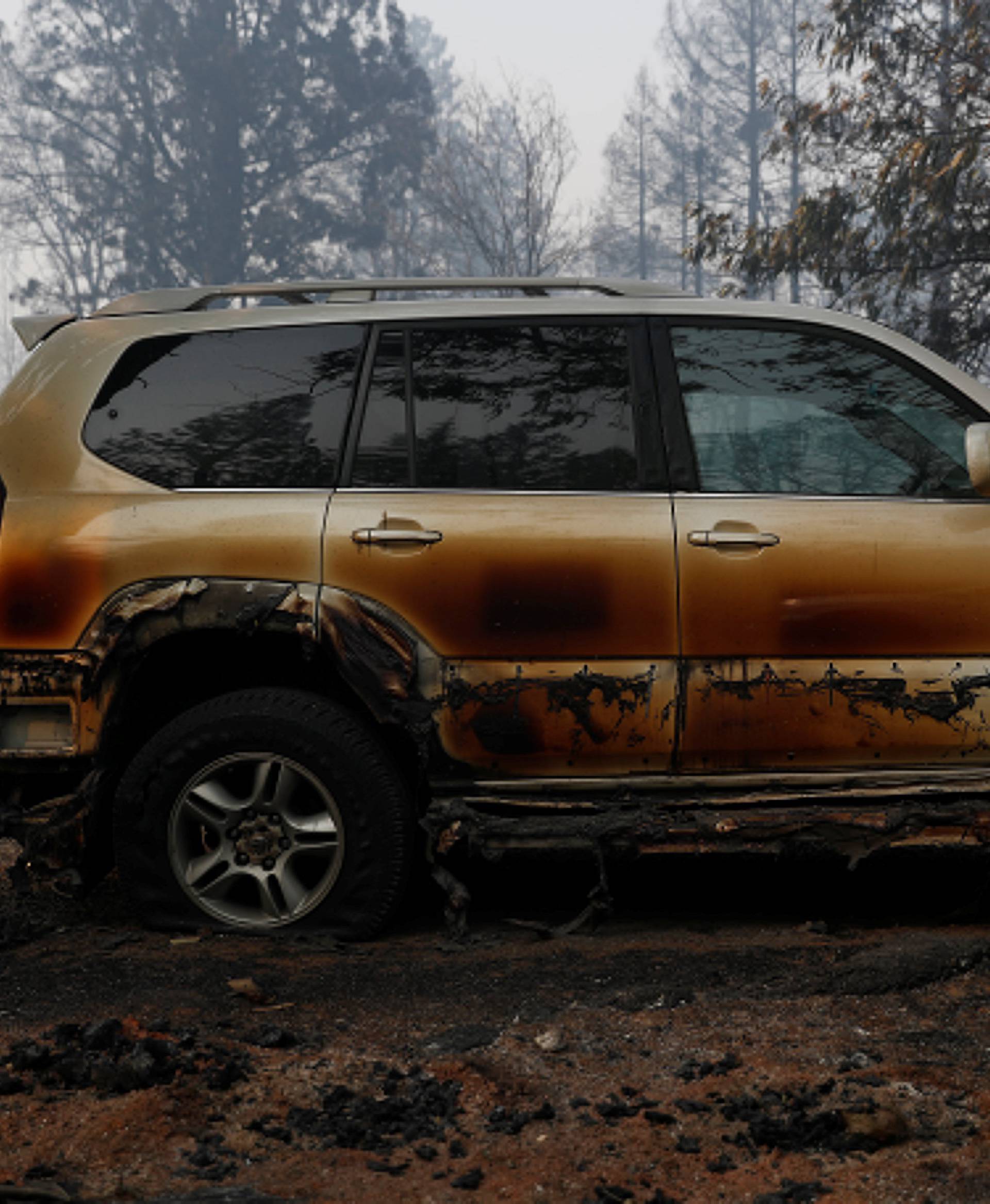 A charred car destroyed by the Camp Fire is seen in Paradise