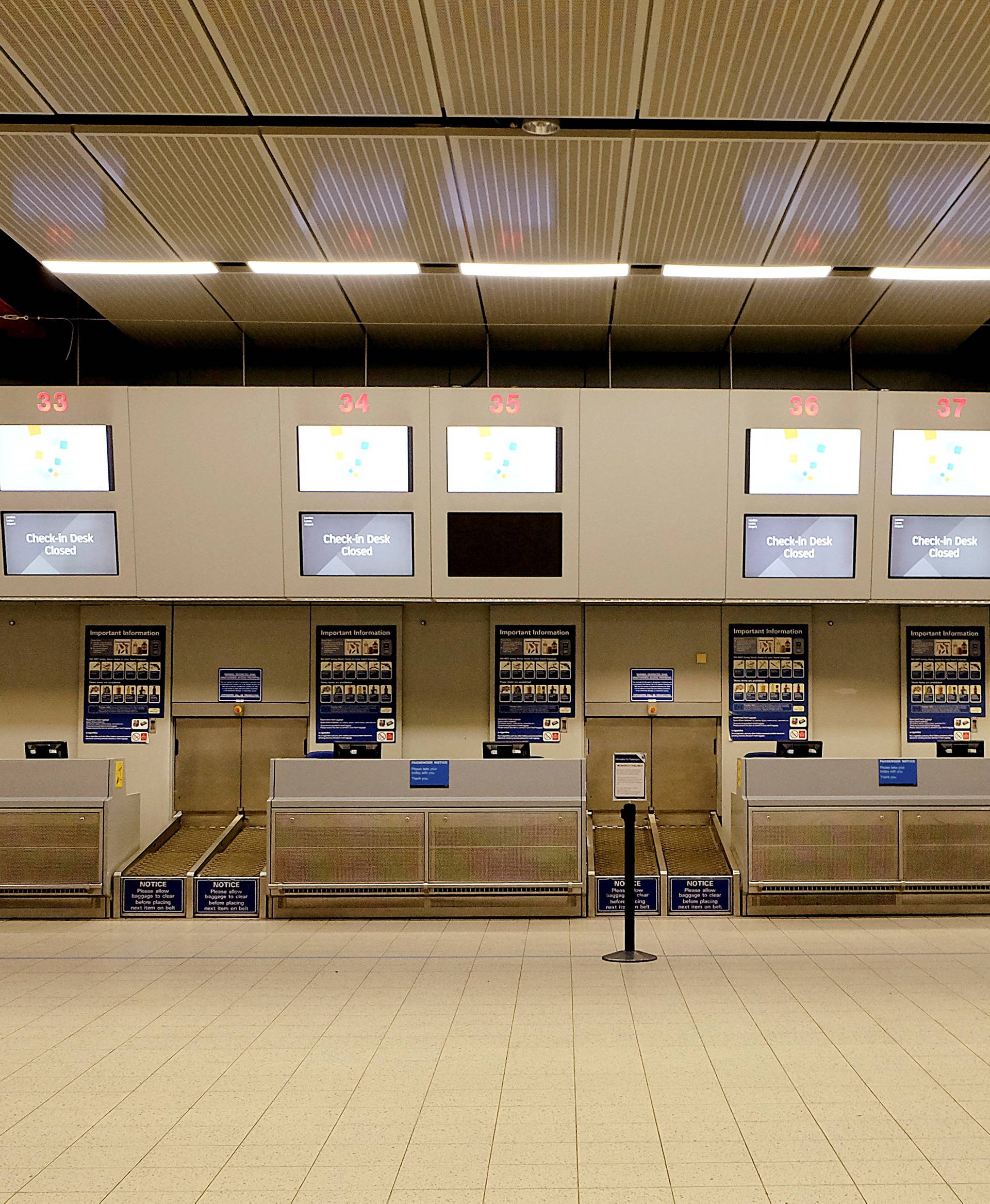 Check-in desks stand empty in the Monarch flights departures area after the airline ceased trading, at Luton airport, Britain