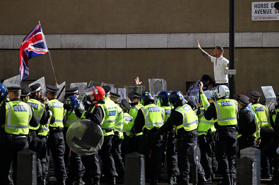 Anti-racism protesters gather to counter anti-immigration rally led by Tommy Robinson, in London