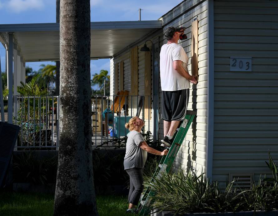 Yana and Jeremy Cauble board up their mobile home in preparation for Hurricane Irma in Homestead