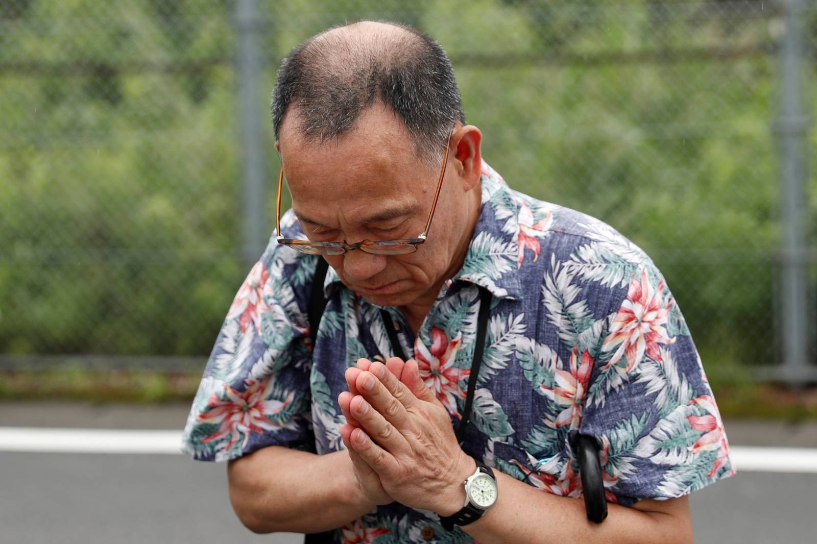 A man prays for the victims of the arson attack near the torched Kyoto Animation building n Kyoto