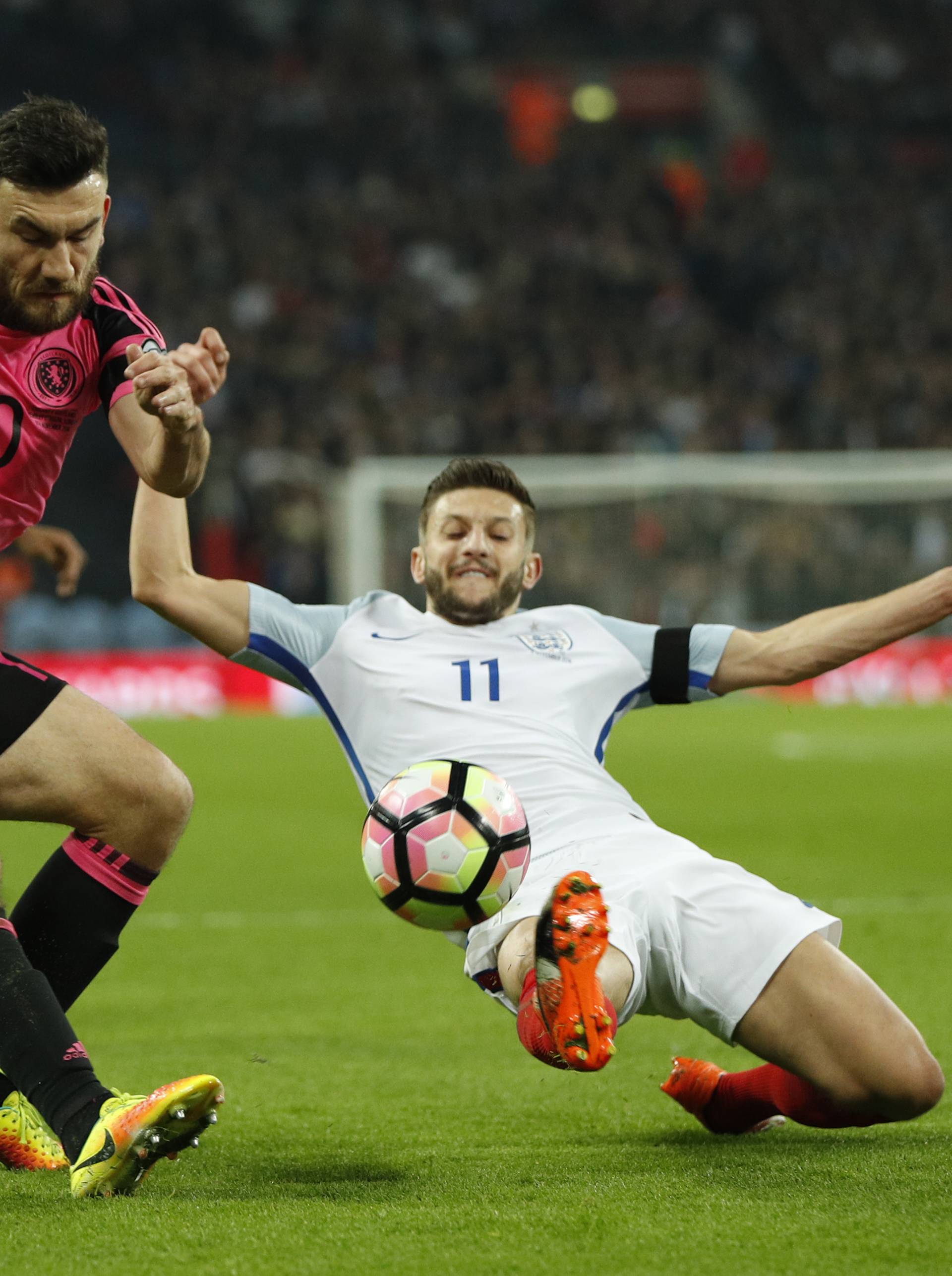 Scotland's Robert Snodgrass in action with England's Adam Lallana