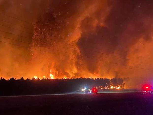 Smoke and flames from bushfire are seen in Gingin, Western Australia