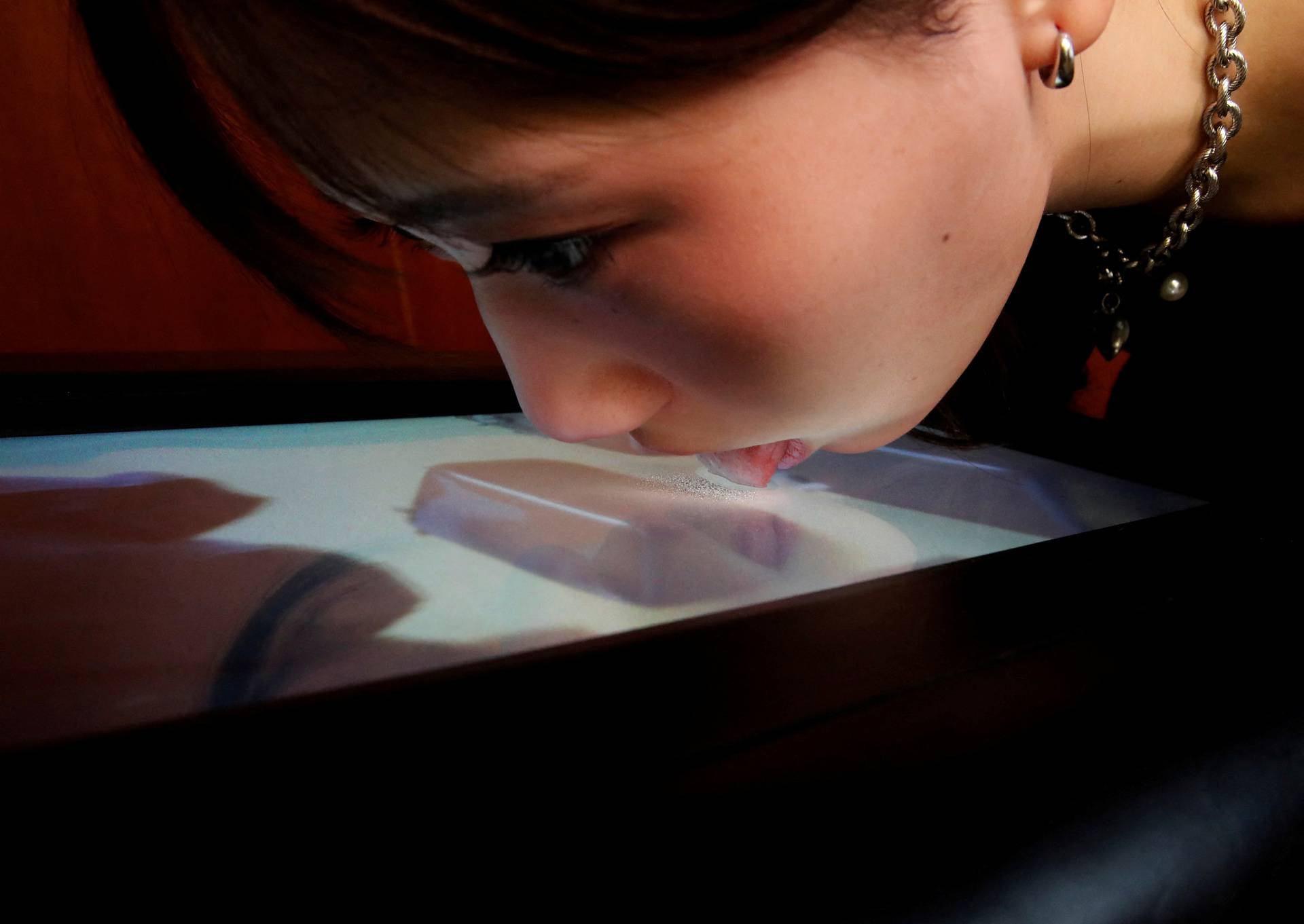 Demonstration of Taste the TV (TTTV), a prototype lickable TV screen that can imitate the flavours of various foods, in Tokyo