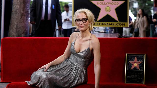 Actor Anderson poses on her star after it was unveiled on the Hollywood Walk of Fame in Los Angeles