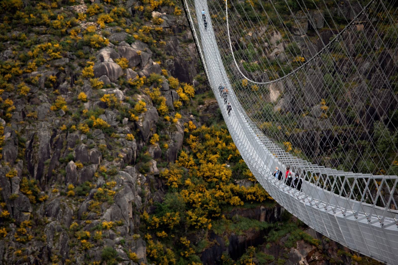 People walk on the world's longest pedestrian suspension bridge '516 Arouca', in Arouca