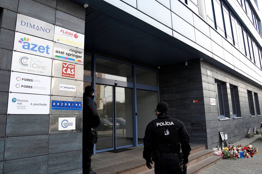 Police officers guard the entrance to the head office of news website Aktuality.sk, where murdered Slovak investigative reporter Jan Kuciak was employed, at Slovak National Uprising Square in Bratislava