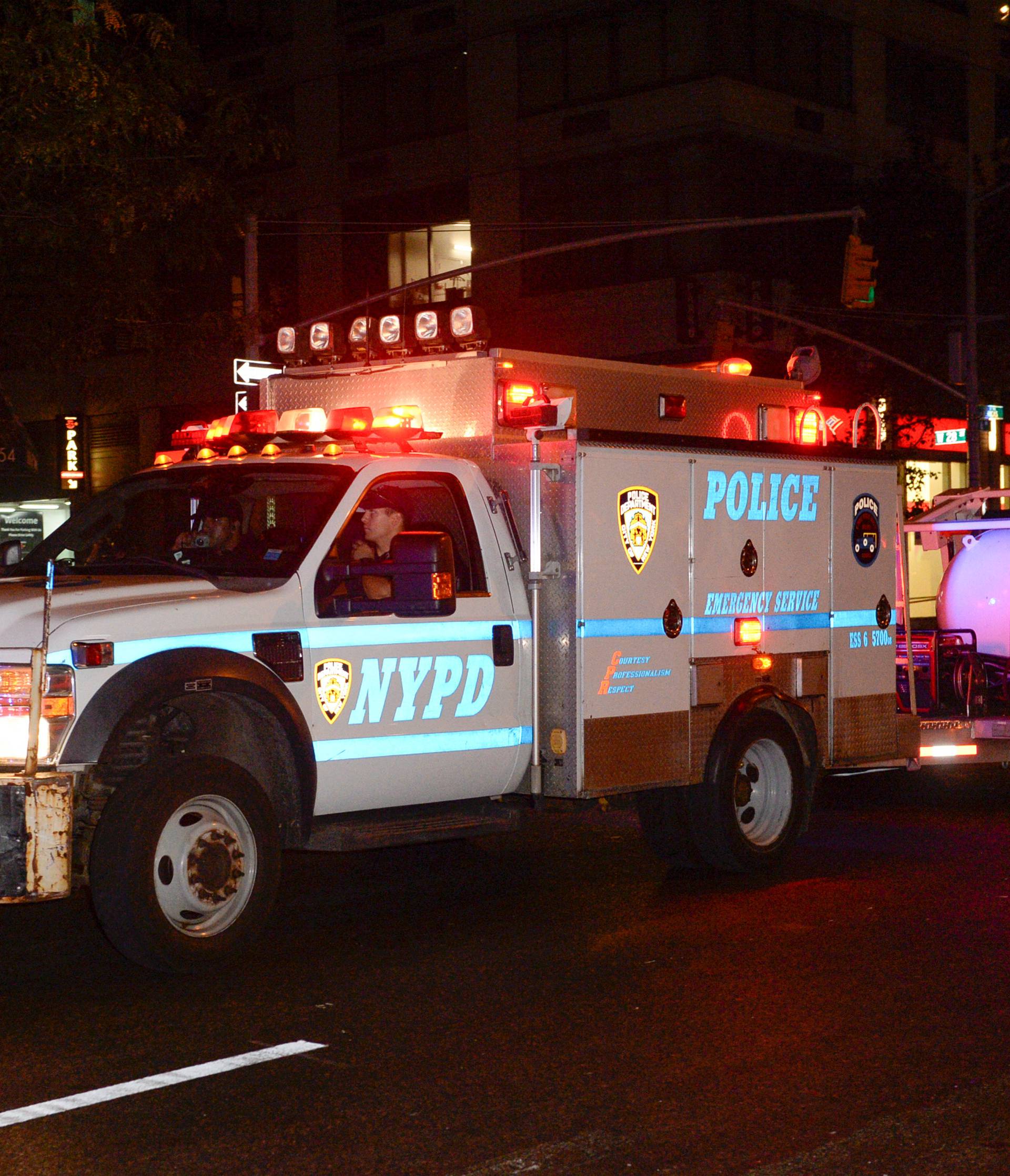 A police truck tows spherical chamber carrying second explosive device from near site of explosion in New York