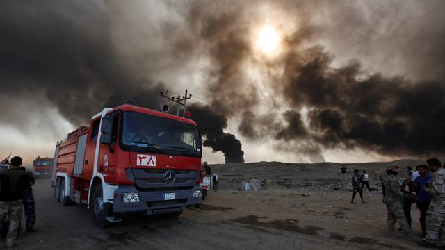 Fire trucks are seen in Qayyara