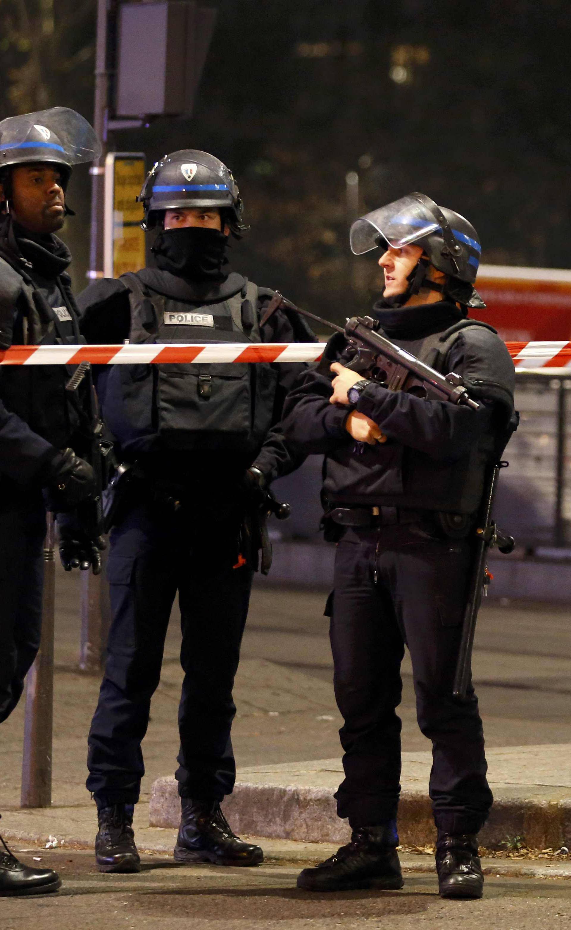 French police secure a street near the travel agency where a gunman has taken hostage about half a dozen people in what appears to be a robbery, a police source said, in Paris
