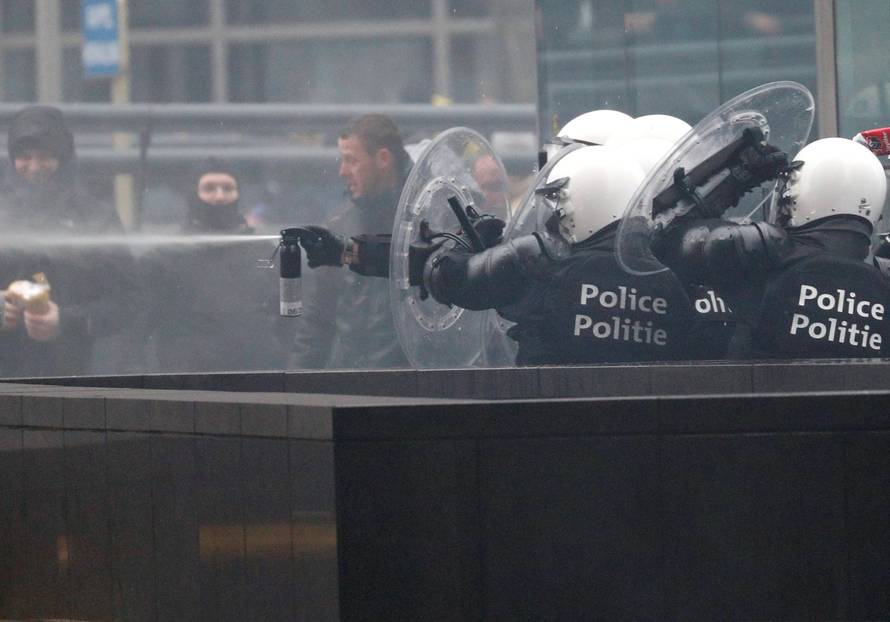 Police officers use tear gas during a protest against Marrakesh Migration Pact in Brussels