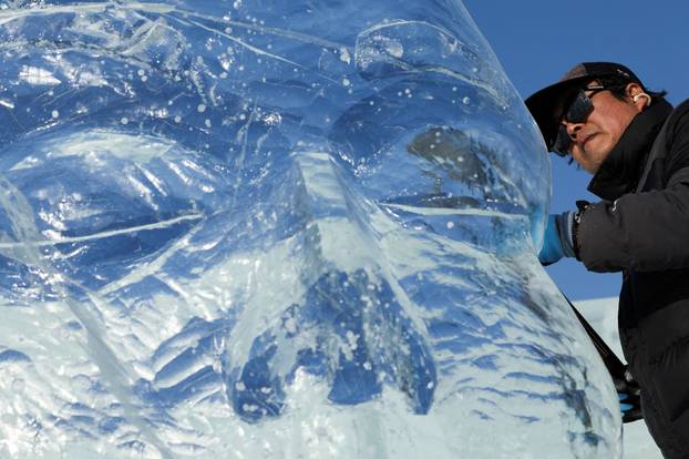 A participant prepares for the ice sculpture contest during the annual Ice and Snow Festival in Harbin